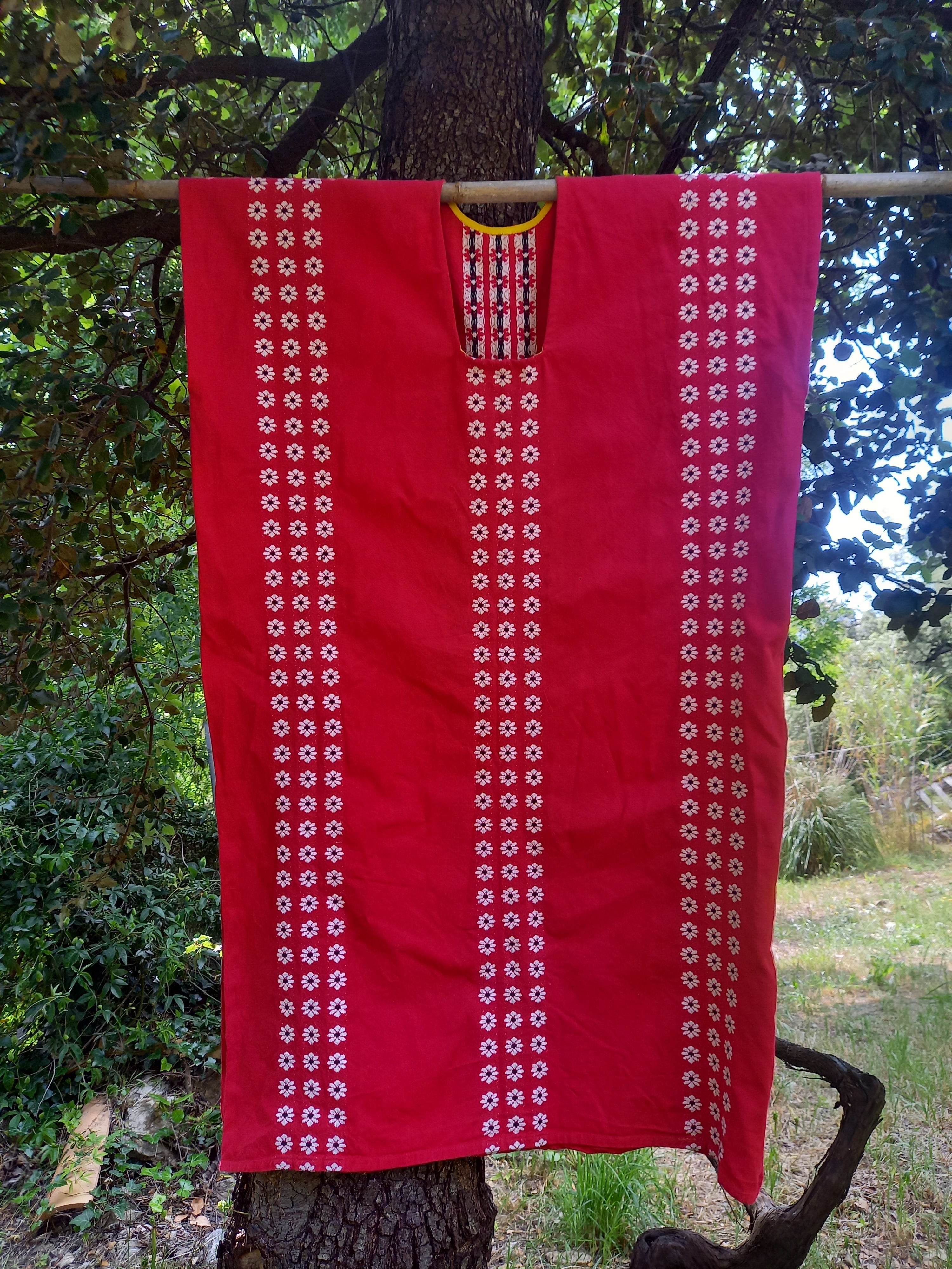 Orient Mallorca kaftan detail of red cotton fabric with white flower pattern
