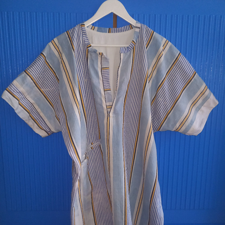 Enza kaftan front view showing vintage Mallorcan textile Mediterranean style, with one pocket on right side.
