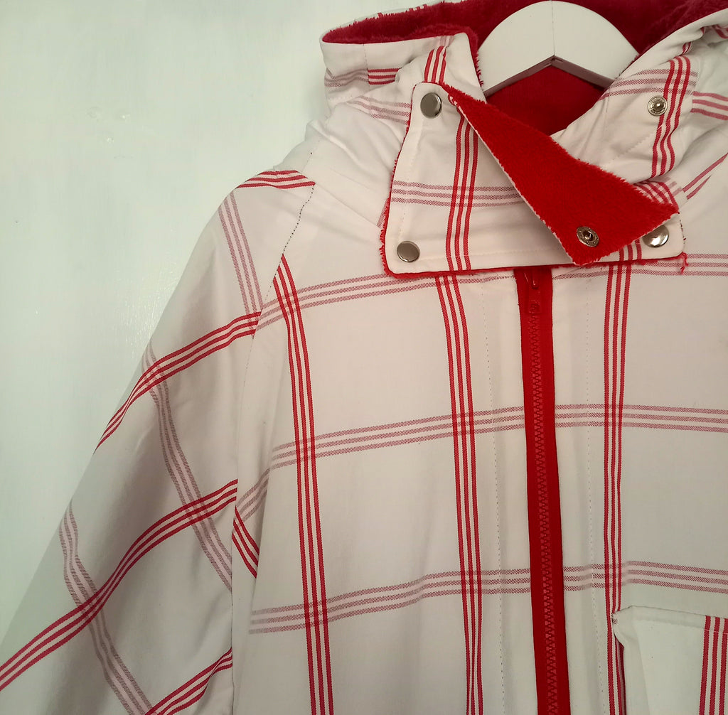 Windy bathrobe close-up of white and red cotton tablecloth fabric detail
